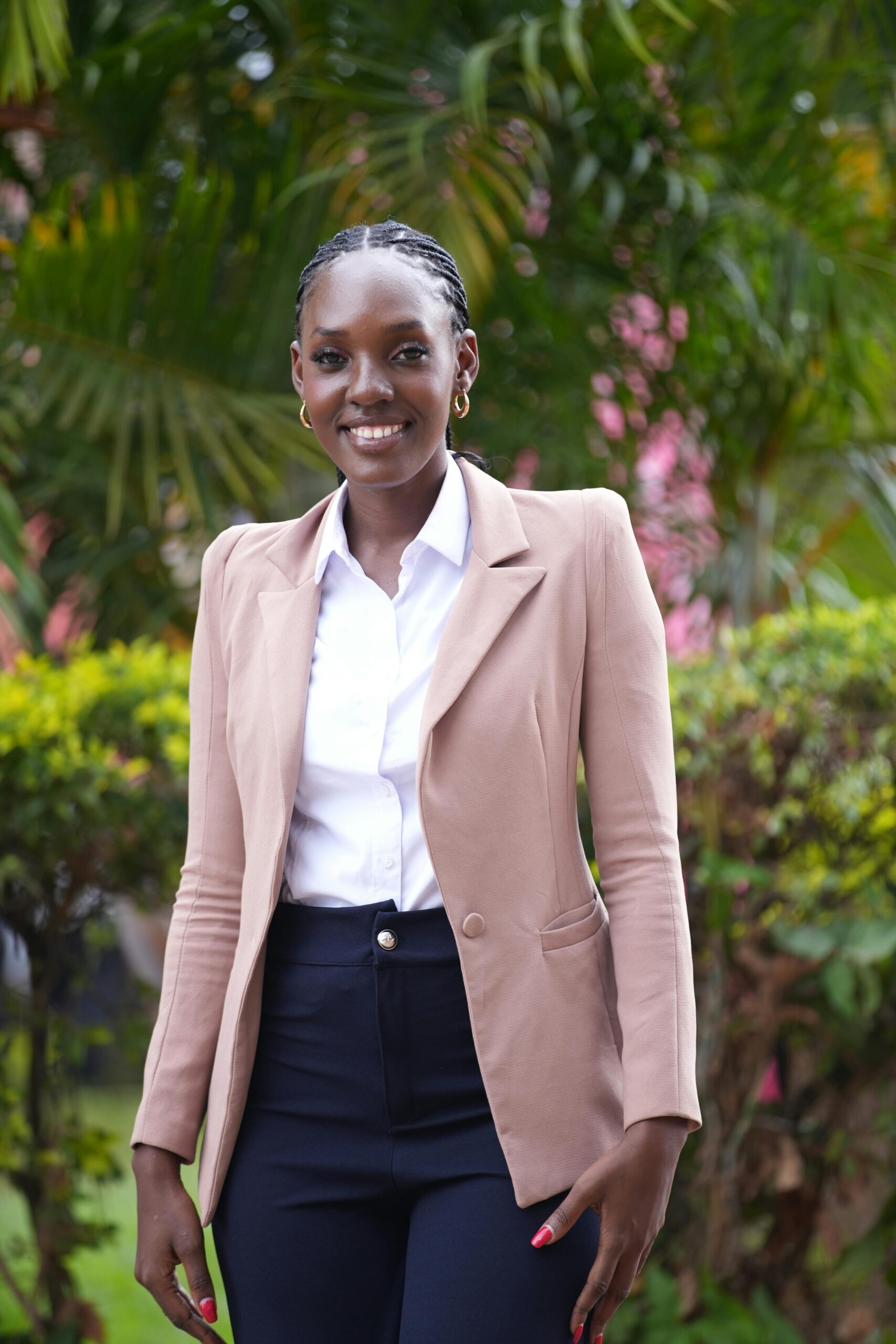 Confident young woman posing outdoors in Kampala, Uganda.